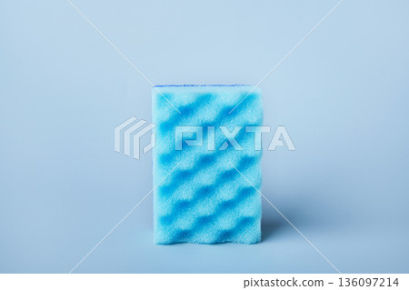 Blue dish sponge used for scrubbing and cleaning kitchen items Blue dish sponge used for scrubbing and cleaning kitchen items 136097214