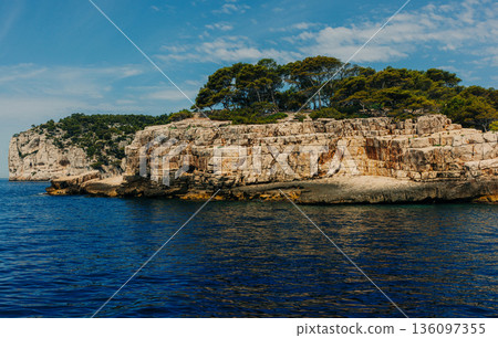Layered stone cliffs topped 136097355