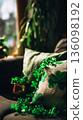 A cozy living room is decorated for St. Patricks Day. Green cushions and shamrocks adorn the sofa. Plants and gold accents complete the festive atmosphere for the holiday 136098192