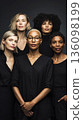 A group of women stands united in a studio for International Women Day on March 8. They face the camera with expressions of solidarity and strength, showcasing diversity 136098199