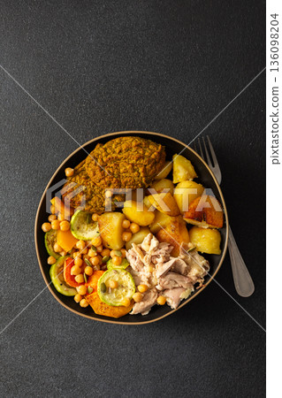 This balanced breakfast showcases baked sweet potato with carrots and zucchini, flavorful carrot and lentil cutlets, chicken breast 136098204