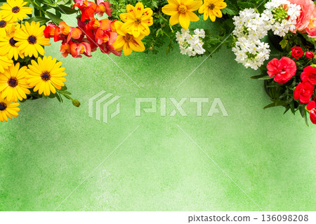 A beautiful array of spring flowers in various colors adorns a balcony, bringing life and brightness to the outdoor area. The flowers add joy and warmth to the setting A beautiful array of spring flowers in various colors adorns a balcony, bringing life and brightness to the outdoor area. The flowers add joy and warmth to the setting 136098208