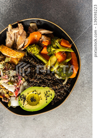 A balanced breakfast bowl with black quinoa, avocado, roast chicken, and sweet potatoes, topped with a fresh cabbage and radish salad A balanced breakfast bowl with black quinoa, avocado, roast chicken, and sweet potatoes, topped with a fresh cabbage and radish salad 136098223