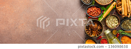 A visually striking arrangement of fresh spices and herbs on a brown surface, highlighting their vivid colors, intricate details, and rich culinary essence, banner A visually striking arrangement of fresh spices and herbs on a brown surface, highlighting their vivid colors, intricate details, and rich culinary essence, banner 136098638