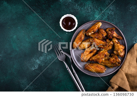 Roasted chicken wings on green table 136098730