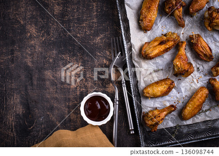 Roasted chicken wings on dark background 136098744