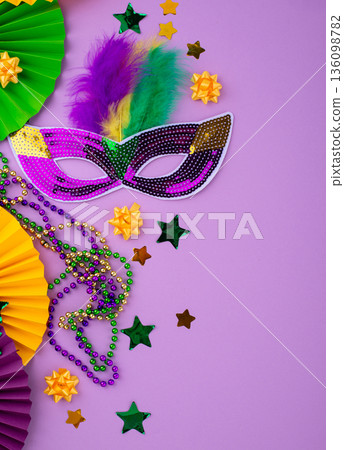 Vibrant Mardi Gras background with mask, beads, and festive decorations 136098782