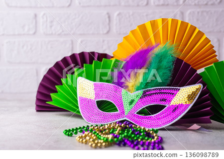 Vibrant Mardi Gras background with mask, beads, and festive decorations 136098789