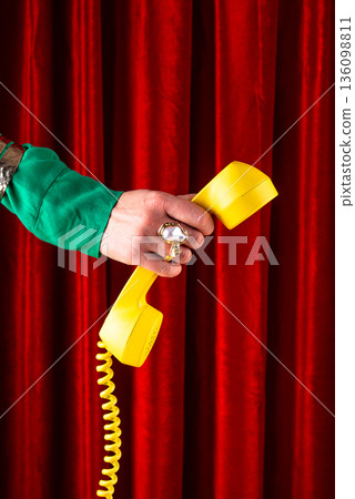 Female hand holding retro phone 136098811