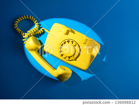 Retro vintage yellow rotary telephone 136098812