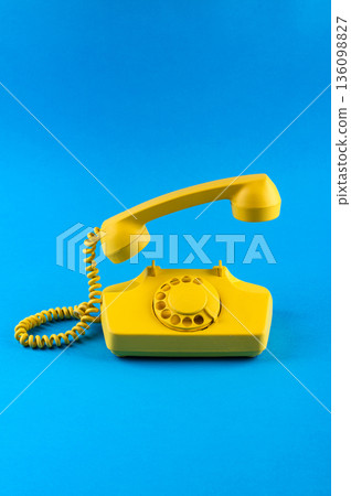 Retro vintage yellow rotary telephone 136098827