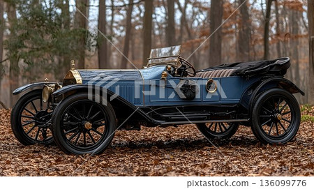 Elegant blue vintage car with gold trim parked among fallen autu 136099776