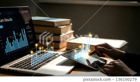 Laptop and Tablet Displaying Interactive Financial Data with Sta 136100279
