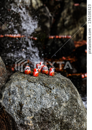 Symbol of determination, good luck charm in Japanese, Many traditional red Daruma doll on the rock at Katsuo-ji temple, Osaka, Japan. 136100323