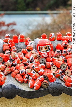 Symbol of determination, good luck charm in Japanese, Many traditional red Daruma doll at Katsuo-ji temple, Osaka, Japan. 136100343