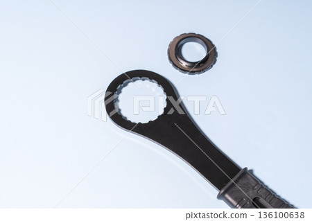 Bottom Bracket Tool and Lockring on a light blue surface. 136100638