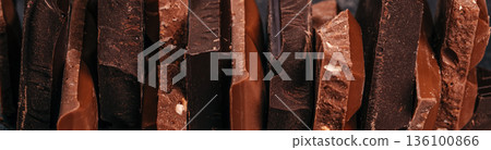 Assorted dark and milk chocolate pieces texture background 136100866