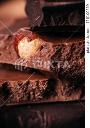 Milk chocolate with whole hazelnut macro texture 136100869