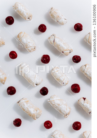 Powdered sugar cherry rugelach cookies pattern on white background, top view Powdered sugar cherry rugelach cookies pattern on white background, top view 136100906
