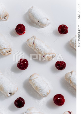 Powdered sugar cherry rugelach cookies pattern on white background, top view Powdered sugar cherry rugelach cookies pattern on white background, top view 136100908