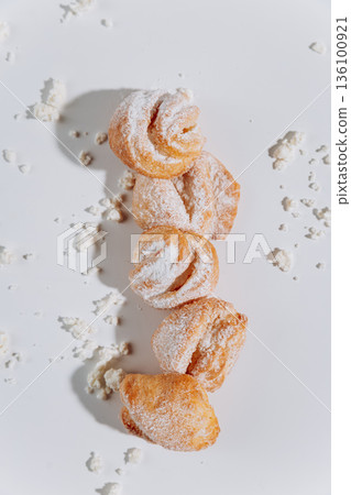 Powdered sugar pastries pattern on white background, flat lay 136100921