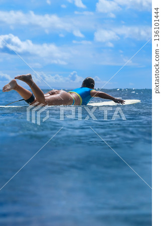 Calm Seaside Relaxation, Serene Woman Lounging On Surfboard Amidst Gentle Waves Calm Seaside Relaxation, Serene Woman Lounging On Surfboard Amidst Gentle Waves 136101444