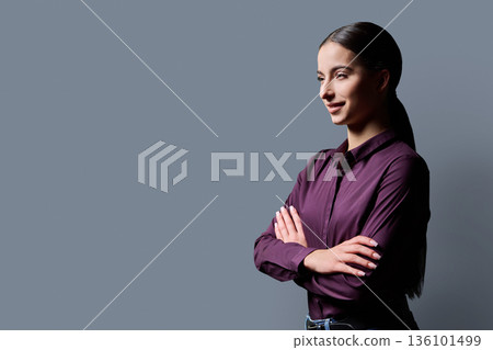 Profile portrait of young confident woman on gray background Profile portrait of young confident woman on gray background 136101499