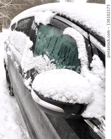 A black car covered in a layer of fresh snow A black car covered in a layer of fresh snow 136102173