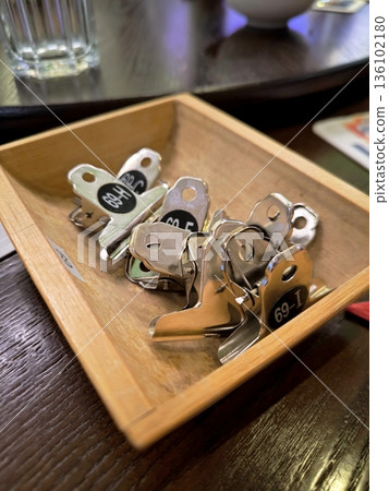 Metal clothespins with table numbers in a wooden tray Metal clothespins with table numbers in a wooden tray 136102180