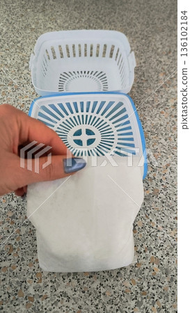 Replacement absorbent bag for household dehumidifier in hand Replacement absorbent bag for household dehumidifier in hand 136102184