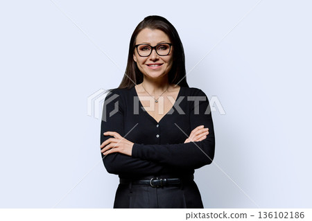 Portrait of smiling confident mature woman on white background Portrait of smiling confident mature woman on white background 136102186