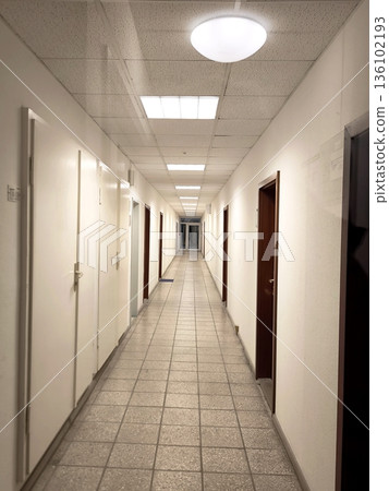 An empty long corridor in a medical facility or dormitory An empty long corridor in a medical facility or dormitory 136102193