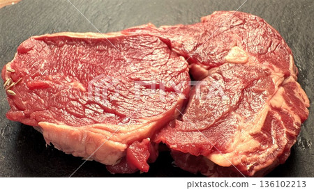 Closeup Marbled Steaks On Dark Surface, Tight Crop Emphasizes Texture, Fat Distribution, And Fresh Red Color For Premium Meat Branding And Culinary Detail Shots 136102213