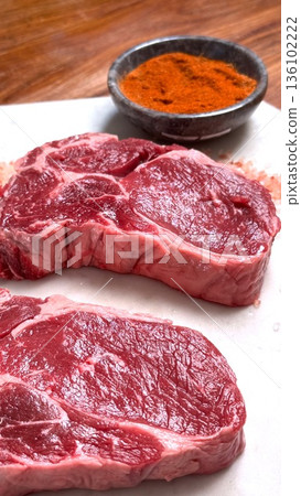 Steaks Seasoned Vividly, Grilled Ribeye With Bold Spices, Homecooked Steaks Seasoned With Vibrant Spices, Casual Barbecue Scene Featuring Marbled Ribeye Steaks Seasoned Vividly Steaks Seasoned Vividly, Grilled Ribeye With Bold Spices, Homecooked Steaks Seasoned With Vibrant Spices, Casual Barbecue Scene Featuring Marbled Ribeye Steaks Seasoned Vividly 136102222