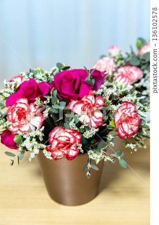 Colorful flower arrangement on the table Colorful flower arrangement on the table 136102578