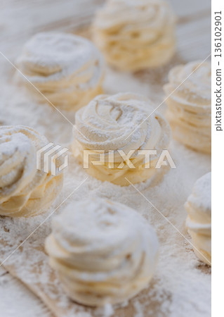 Vanilla marshmallow swirl treats on parchment paper, closeup Vanilla marshmallow swirl treats on parchment paper, closeup 136102901