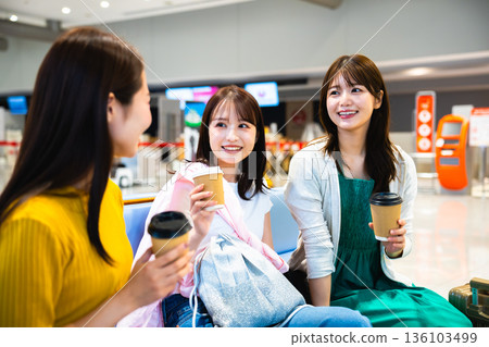 Three women chatting at the airport. Photo courtesy of Kansai International Airport (KIX). 136103499