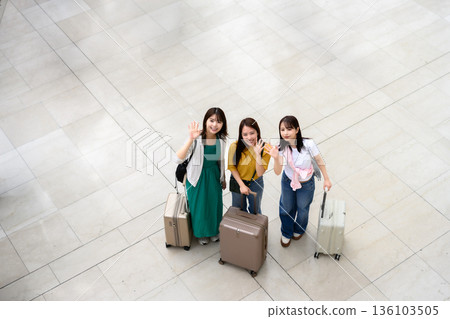 Three women waving at the airport. Photo courtesy of Kansai International Airport (KIX). Three women waving at the airport. Photo courtesy of Kansai International Airport (KIX). 136103505