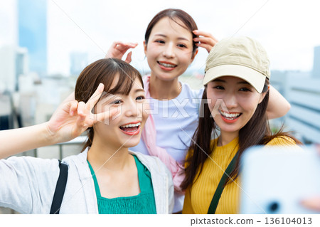 Woman taking a selfie in the city 136104013