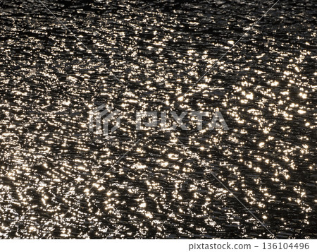 The surface of the river reflecting the morning sun The surface of the river reflecting the morning sun 136104496