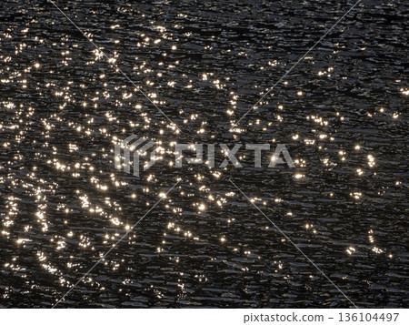 The surface of the river reflecting the morning sun The surface of the river reflecting the morning sun 136104497