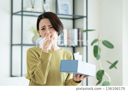 Middle-aged woman suffering from hay fever 136106170