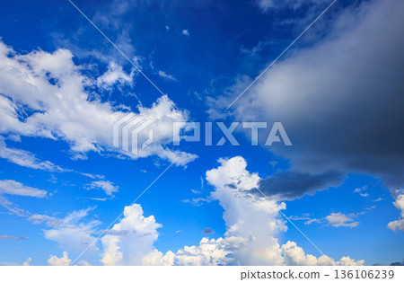 A rainbow appears in the summer blue sky and a huge cumulonimbus cloud A rainbow appears in the summer blue sky and a huge cumulonimbus cloud 136106239