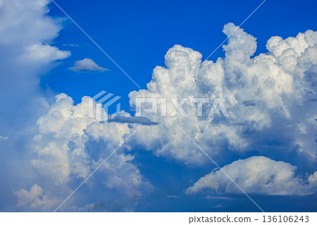 A rainbow appears in the summer blue sky and a huge cumulonimbus cloud A rainbow appears in the summer blue sky and a huge cumulonimbus cloud 136106243