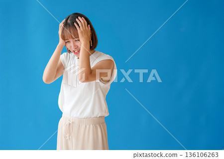 A woman holding a head A woman holding a head 136106263