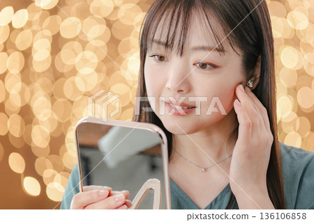 Woman looking in the mirror with a smile Woman looking in the mirror with a smile 136106858