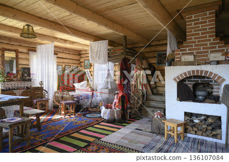 Interior of a 19th-century Russian hut with big oven, bed and cradle suspended from the ceiling Interior of a 19th-century Russian hut with big oven, bed and cradle suspended from the ceiling 136107084