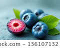 Fresh Organic Blueberries and Juicy Plum with Green Leaves 136107132