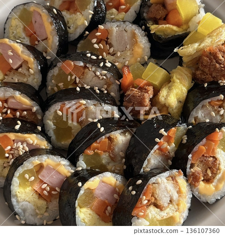 Delicious kimbap rolls filled with fresh vegetables, seasoned rice, and savory proteins, all wrapped in crisp seaweed. A perfect combination of flavor and texture in every bite. Delicious kimbap rolls filled with fresh vegetables, seasoned rice, and savory proteins, all wrapped in crisp seaweed. A perfect combination of flavor and texture in every bite. 136107360