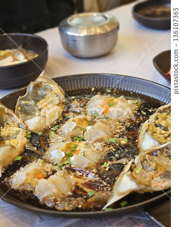 Ganjang Gejang, a Korean delicacy, consists of raw crabs marinated in soy sauce, offering a savory, umami-packed flavor. A must-try for seafood lovers, it's often served with rice. Ganjang Gejang, a Korean delicacy, consists of raw crabs marinated in soy sauce, offering a savory, umami-packed flavor. A must-try for seafood lovers, it's often served with rice. 136107365